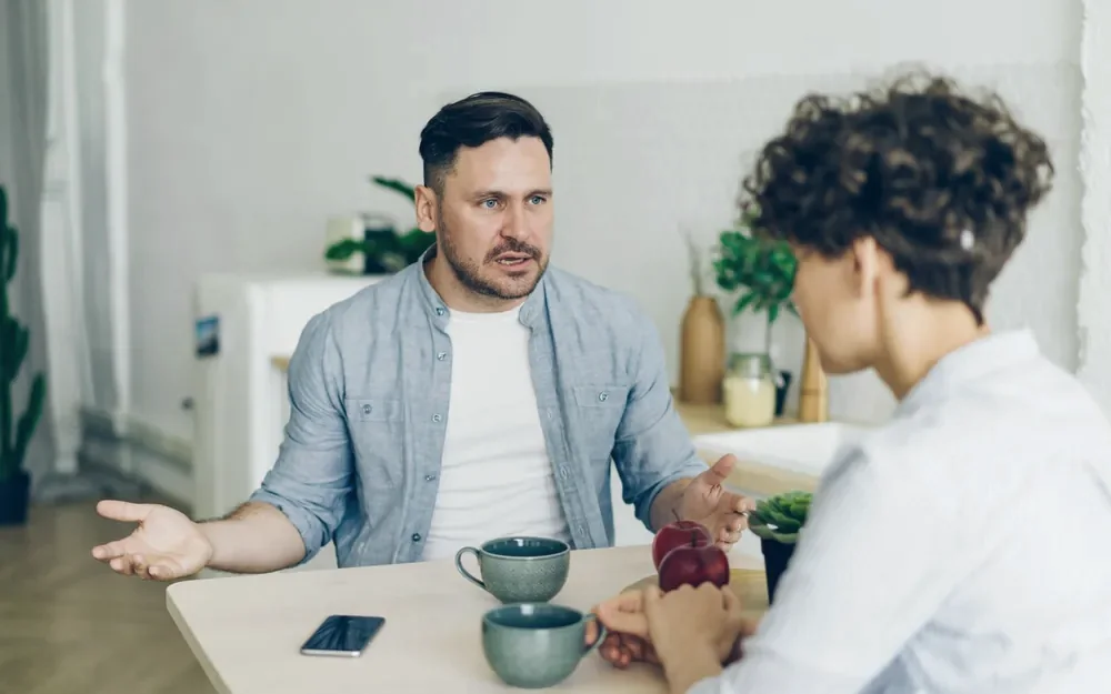 Two adults discussing next steps at a table